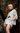 Woman wearing Riviera Reverie patterned outfit against a rocky background